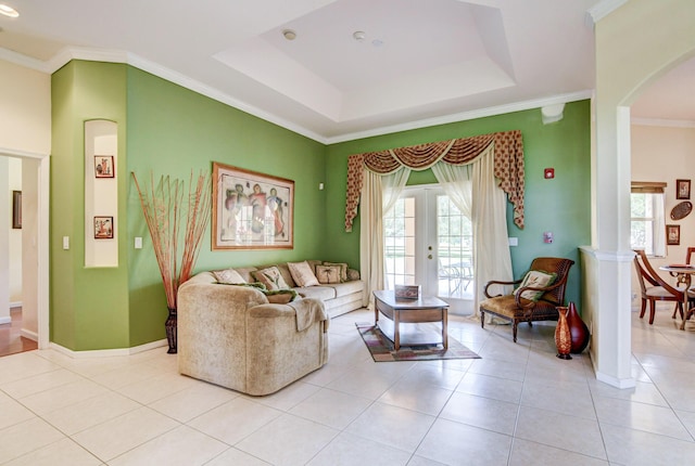 tiled living room with a raised ceiling and crown molding