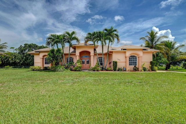 mediterranean / spanish-style house with a front yard