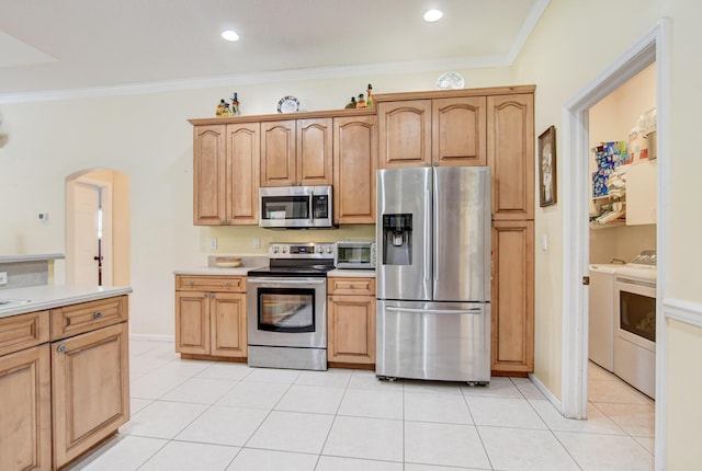 kitchen featuring independent washer and dryer, ornamental molding, light tile floors, and appliances with stainless steel finishes