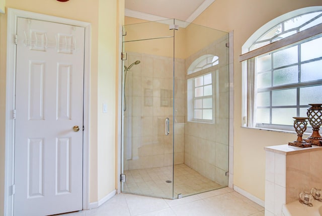 bathroom with crown molding, an enclosed shower, and tile flooring