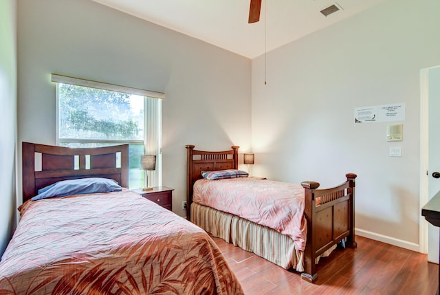 bedroom with ceiling fan and dark wood-type flooring