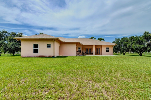 back of property with a lawn