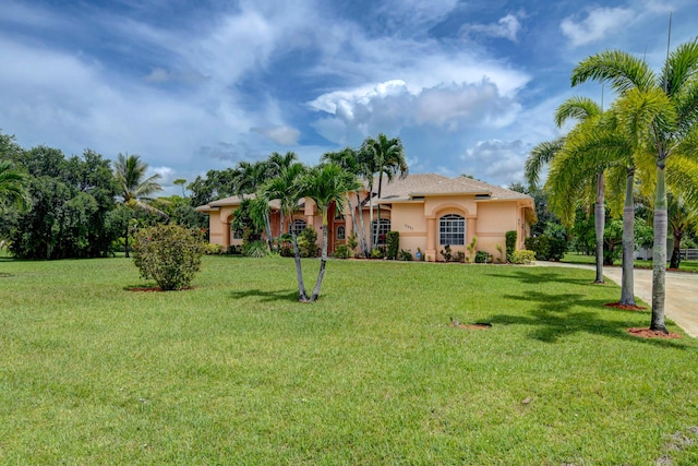 mediterranean / spanish house featuring a front lawn