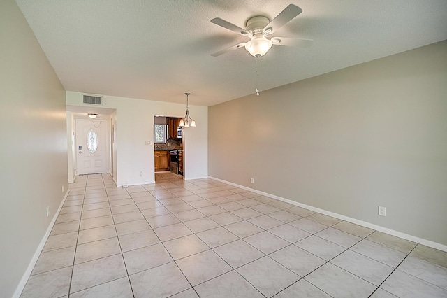 200 Waterway Dr S Unit 102, Lantana, FL 33462 - unfurnished living room with a textured ceiling, ceiling fan with notable chandelier, and light tile floors