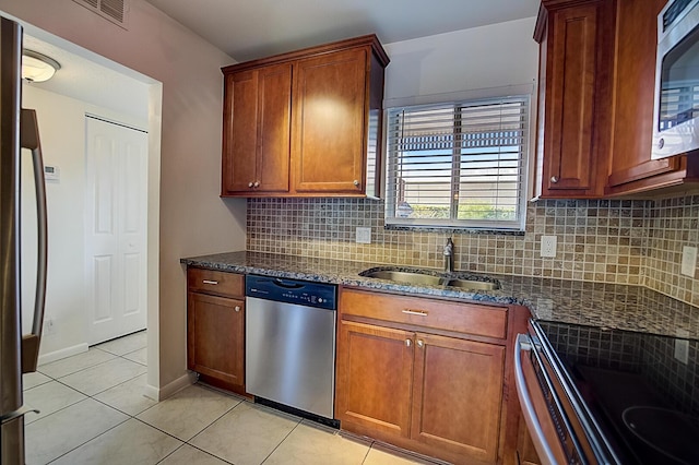200 Waterway Dr S Unit 102, Lantana, FL 33462 - kitchen featuring backsplash, stainless steel appliances, sink, and dark stone counters