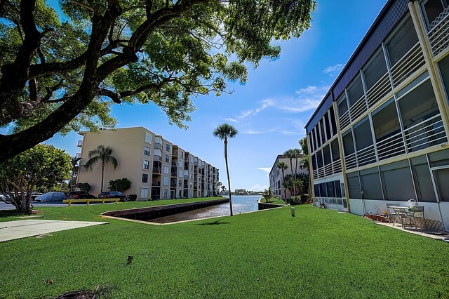 200 Waterway Dr S Unit 102, Lantana, FL 33462 - view of property's community featuring a lawn and a water view