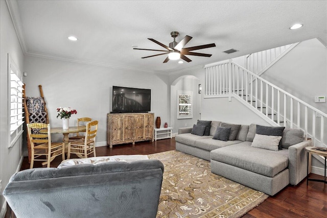 living room with a textured ceiling, crown molding, ceiling fan, and dark hardwood / wood-style flooring