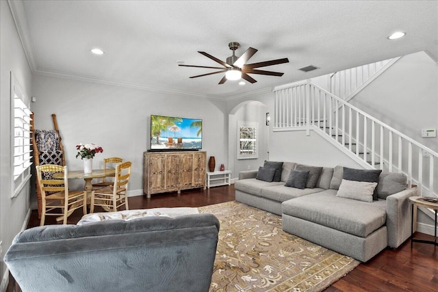 living room featuring ornamental molding, a textured ceiling, ceiling fan, and dark wood-type flooring