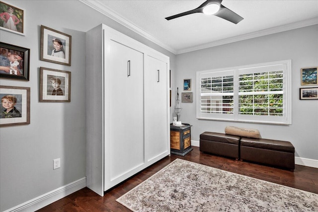 sitting room with crown molding, dark hardwood / wood-style floors, and ceiling fan