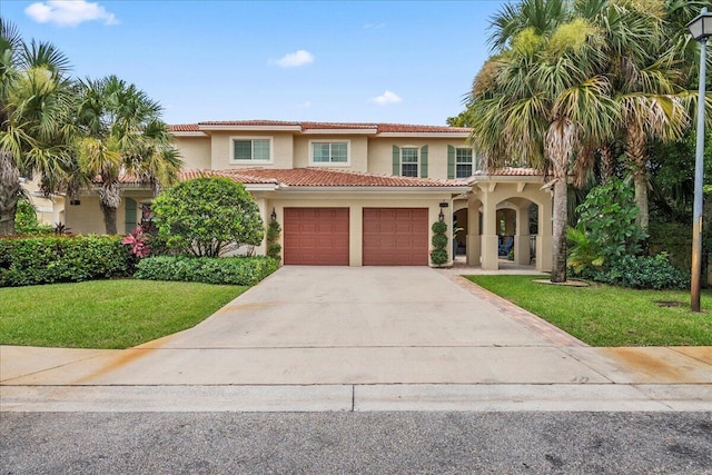 mediterranean / spanish home with a front lawn and a garage