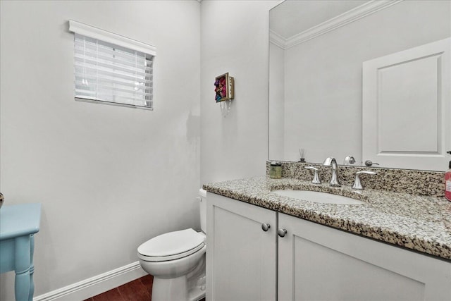 bathroom featuring wood-type flooring, crown molding, toilet, and large vanity