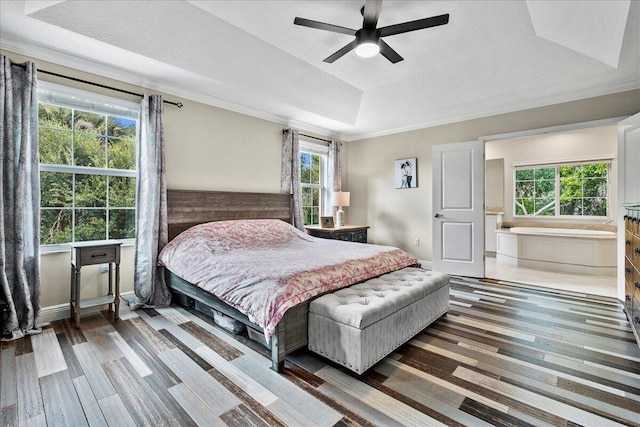 bedroom with ceiling fan, a textured ceiling, a raised ceiling, and dark hardwood / wood-style flooring