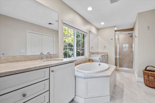 bathroom featuring independent shower and bath, tile flooring, and vanity