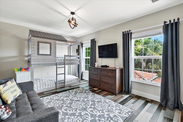 bedroom with dark hardwood / wood-style floors