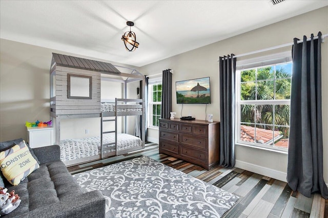 bedroom with dark wood-type flooring