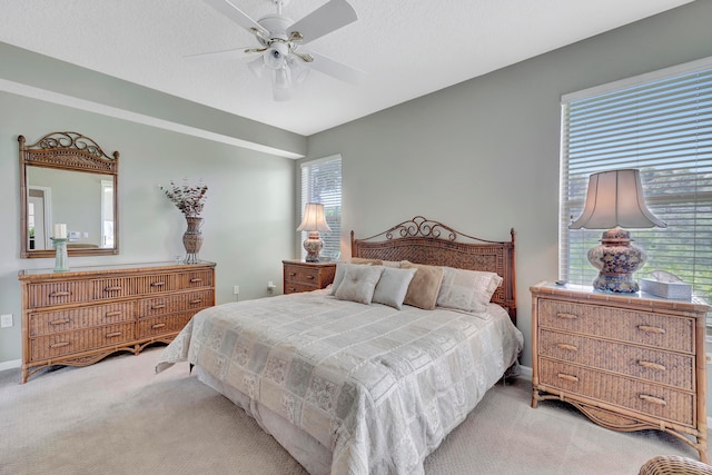 bedroom featuring light carpet and ceiling fan