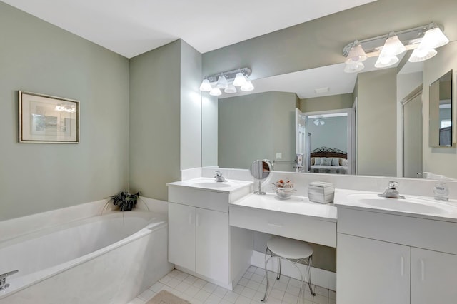 bathroom with a bathing tub, tile floors, oversized vanity, and dual sinks