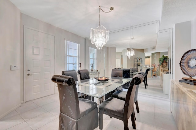 tiled dining space featuring a chandelier