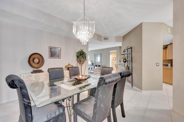 tiled dining room with a notable chandelier