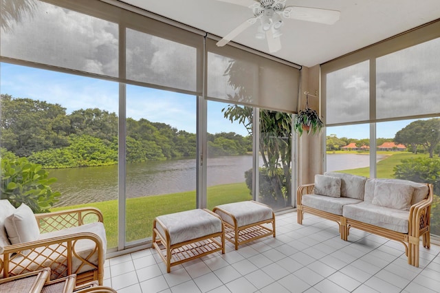 sunroom with a water view and ceiling fan