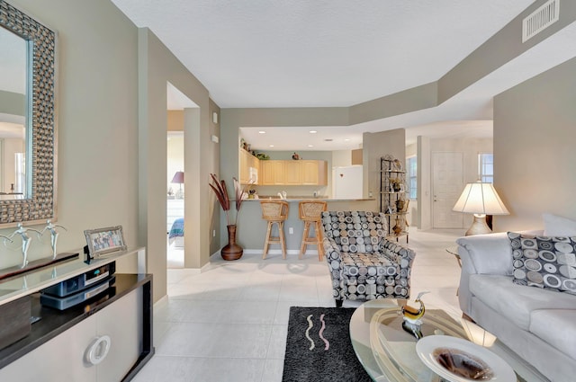 living room with a healthy amount of sunlight and light tile floors