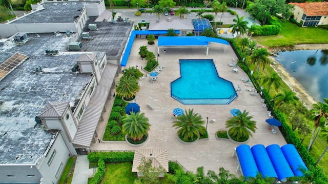 view of swimming pool featuring a water view and a patio area