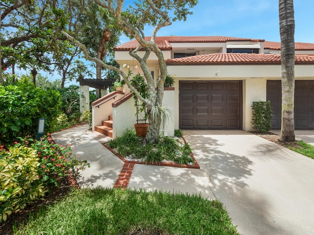 mediterranean / spanish home with a garage