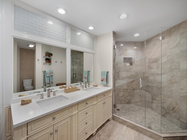 bathroom featuring walk in shower, toilet, double sink vanity, and tile flooring