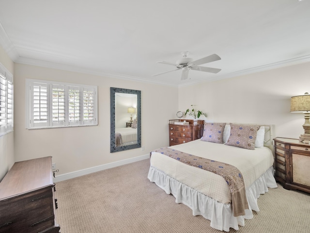 carpeted bedroom featuring crown molding and ceiling fan