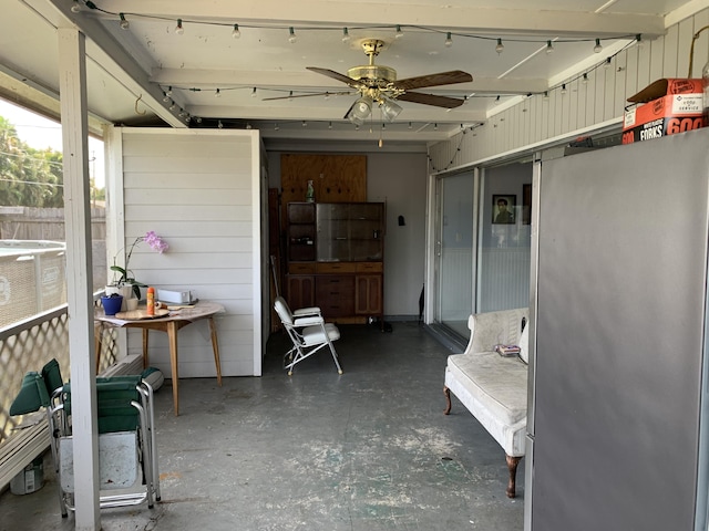 sunroom / solarium featuring ceiling fan