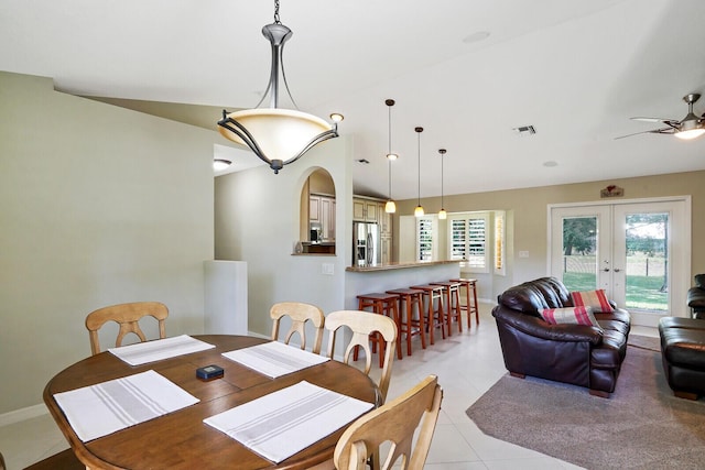 tiled dining room featuring vaulted ceiling, ceiling fan, and french doors