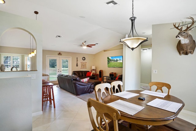 tiled dining area with lofted ceiling, ceiling fan, and french doors