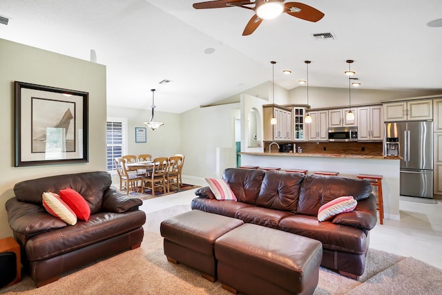 living room featuring ceiling fan and lofted ceiling