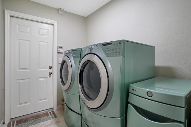 washroom with separate washer and dryer and tile flooring