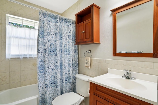 full bathroom with tile walls, toilet, vanity, and shower / bath combo