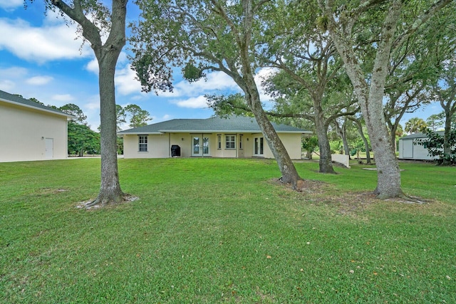 exterior space featuring a lawn and a storage shed