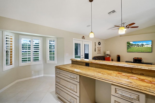 kitchen with french doors, ceiling fan, light tile floors, vaulted ceiling, and decorative light fixtures