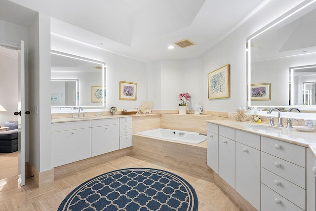 bathroom with tiled tub and oversized vanity