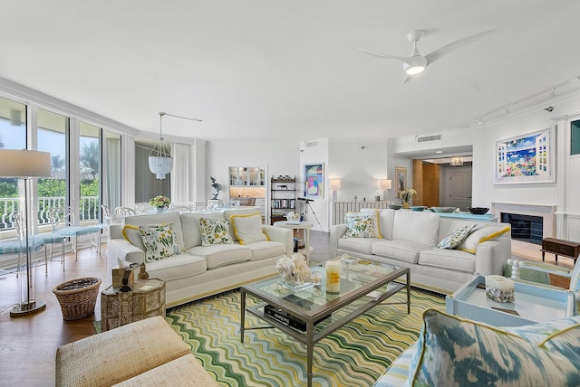 living room featuring crown molding, ceiling fan, and hardwood / wood-style flooring