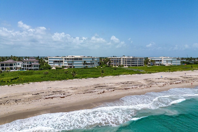 drone / aerial view with a beach view and a water view