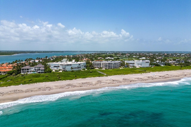 drone / aerial view with a water view and a beach view