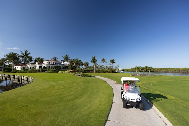 view of home's community featuring a water view and a yard