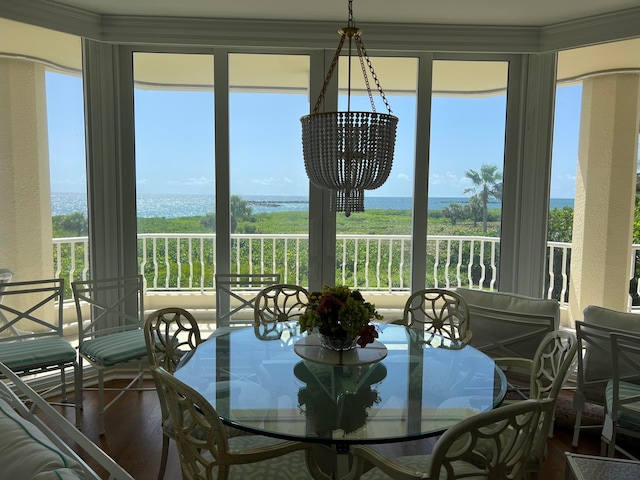 sunroom featuring an inviting chandelier