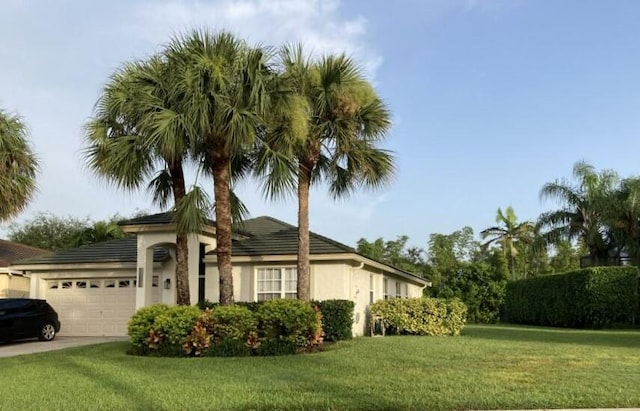 view of front facade with a front yard and a garage