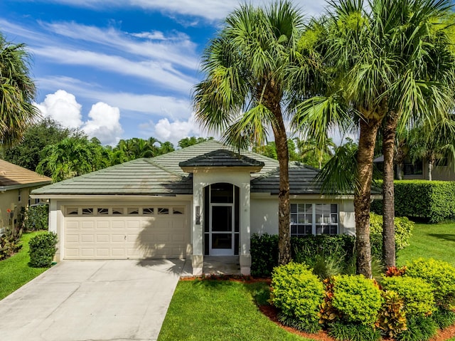 view of front of property with a front lawn and a garage