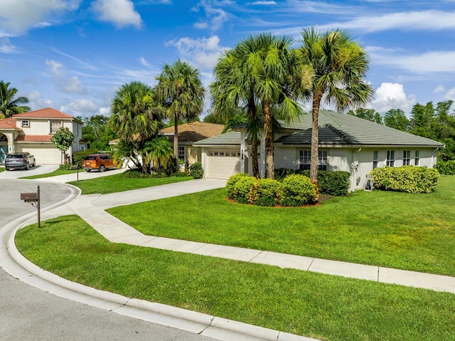 view of front of house with a front yard and a garage