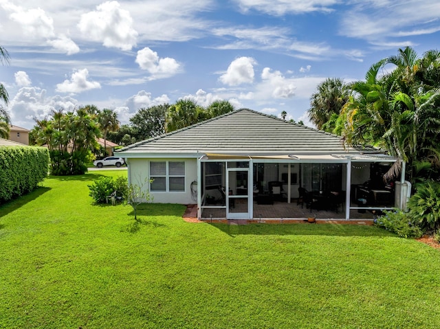 rear view of property with a yard and a patio