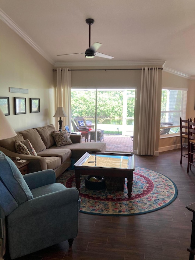 living room with vaulted ceiling, ornamental molding, ceiling fan, and dark hardwood / wood-style flooring