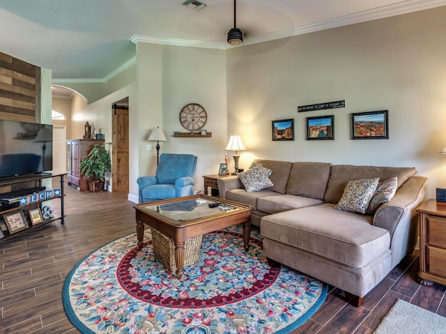 living room featuring dark hardwood / wood-style floors, ceiling fan, and ornamental molding