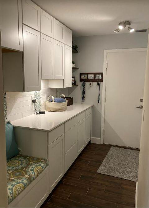 kitchen featuring white cabinets, tasteful backsplash, and dark hardwood / wood-style flooring